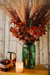 Chic artificial pampas grasses, eucalyptus and cotinus in a stylish green glass vase. Perfect for businesses, large spaces in a home or as a gift.