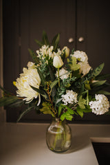 Luxury artificial white tulips, hydrangea, agapanthus and chrysanthemums mingled with the highest quality viburnum and eucalyptus. Expertly arranged by our team of florists into a choice of vases or available as a beautifully wrapped bouquet.