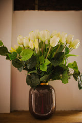 Luxury artificial white tulips and green salal foliage expertly arranged by our team of florists into a choice of light green glass or taupe metal vase or available as a beautifully wrapped bouquet.