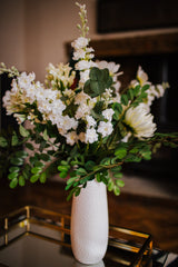 Luxury artificial white cosmos, delphinium, agapanthus and chrysanthemums mingled with the highest quality robinia and eucalyptus. Expertly arranged by our team of florists into a choice of white ceramic or green glass vase or available as a beautifully wrapped bouquet.