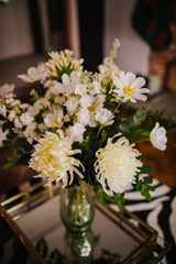 Luxury artificial white cosmos, delphinium, agapanthus and chrysanthemums mingled with the highest quality robinia and eucalyptus. Expertly arranged by our team of florists into a choice of white ceramic or green glass vase or available as a beautifully wrapped bouquet.
