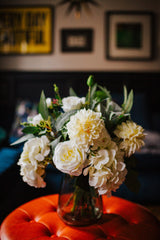 Luxury artificial peony, spray roses, dahlia and hydrangea in creamy shades blended with seeded eucalyptus and soft grey lambs ear foliage.  Available arranged in a green glass vase or as a gift wrapped bouquet.