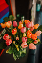 Luxury artificial tulips and salal foliage expertly arranged by our team of florists into a choice of dusky pink metal vase or light green glass vase or available as a beautifully wrapped bouquet.