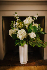 Luxury artificial hydrangea, orange blossom, viburnum and seasonal foliage. Expertly arranged by our team of florists into a tall white ceramic vase or available as a beautifully wrapped bouquet, perfect for larger spaces.