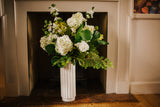 Luxury artificial hydrangea, orange blossom, viburnum and seasonal foliage. Expertly arranged by our team of florists into a tall white ceramic vase or available as a beautifully wrapped bouquet, perfect for larger spaces.