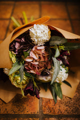 An eye catching abundance of hydrangea, ranunculus, anemone, lisianthus, viburnum and eucalyptus. Expertly arranged by our team of florists into a choice of light green ribbed glass vase or green bamboo glass vase or available as a beautifully wrapped bouquet.