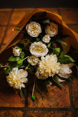Luxury artificial peony, spray roses, dahlia and hydrangea in creamy shades blended with seeded eucalyptus and soft grey lambs ear foliage.  Available arranged in a green glass vase or as a gift wrapped bouquet.
