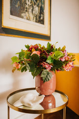 Artificial pink hellebores arranged with foliage into a sleek blush pink vase or available as a gift wrapped bouquet.  Perfect for home or to gift!