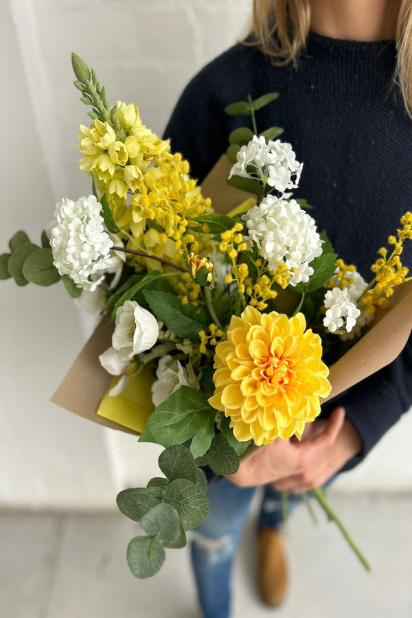 Freshly-picked seasonality with hellebore and mimosa complimenting the delicate petals of campanula, viburnum snowball, dahlia and eucalyptus in a beautiful hand-tied bouquet.   A mood boosting design created by our expert florists, the perfect gift for a loved one or yourself! 