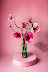 Our bold Hattie arrangement is guaranteed to inject colour, personality and energy into any space.  The joyful pink toned poppies are perfect to gift or to keep!  UNBOX & ENJOY Our skilful team of florists have styled the stems in a green glass  bottle vase or they can be made into a beautifully wrapped bouquet.  