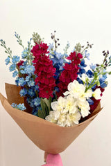 Freshen your interior with our show-stopping Sapphire.  A luxurious display of blue and white delphinium combined with hot pink stocks.    UNBOX & ENJOY Perfect for larger spaces, these extravagant stems have been hand-tied and gift wrapped by our floristry team ready to place in a tall vase of your choice.