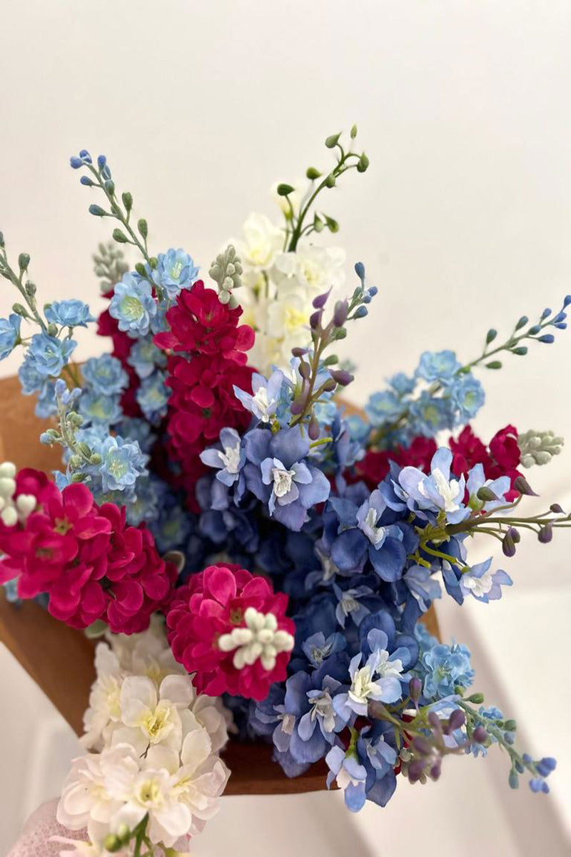 Freshen your interior with our show-stopping Sapphire.  A luxurious display of blue and white delphinium combined with hot pink stocks.    UNBOX & ENJOY Perfect for larger spaces, these extravagant stems have been hand-tied and gift wrapped by our floristry team ready to place in a tall vase of your choice.