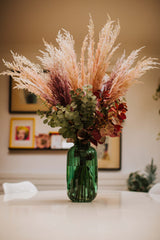 Chic artificial pampas grasses, eucalyptus and cotinus in a stylish green glass vase. Perfect for businesses, large spaces in a home or as a gift.