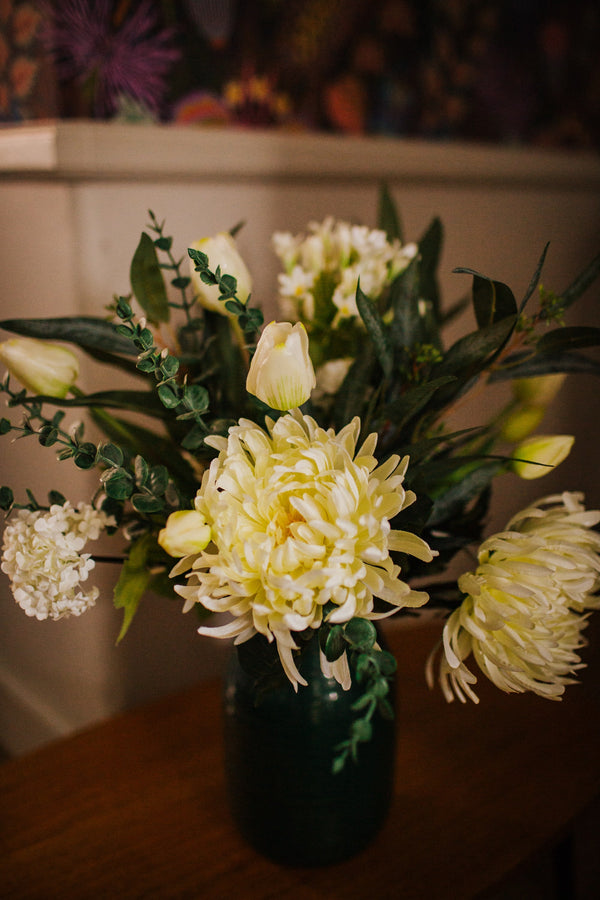 Luxury artificial white tulips, hydrangea, agapanthus and chrysanthemums mingled with the highest quality viburnum and eucalyptus. Expertly arranged by our team of florists into a choice of vases or available as a beautifully wrapped bouquet.
