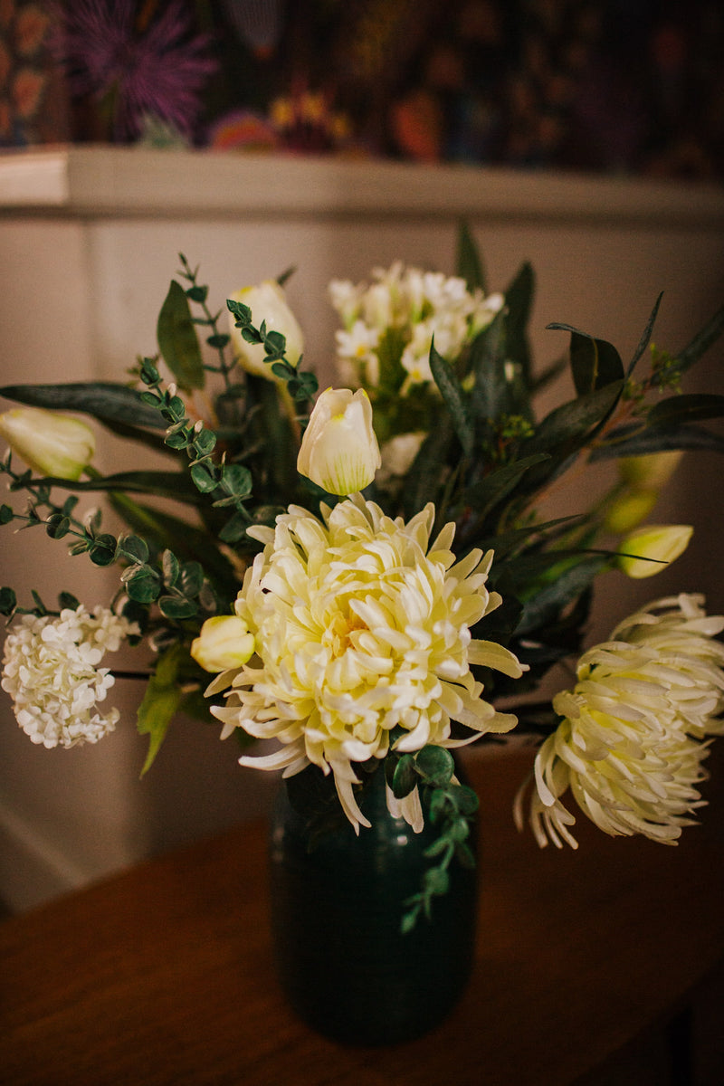 Luxury artificial white tulips, hydrangea, agapanthus and chrysanthemums mingled with the highest quality viburnum and eucalyptus. Expertly arranged by our team of florists into a choice of vases or available as a beautifully wrapped bouquet.