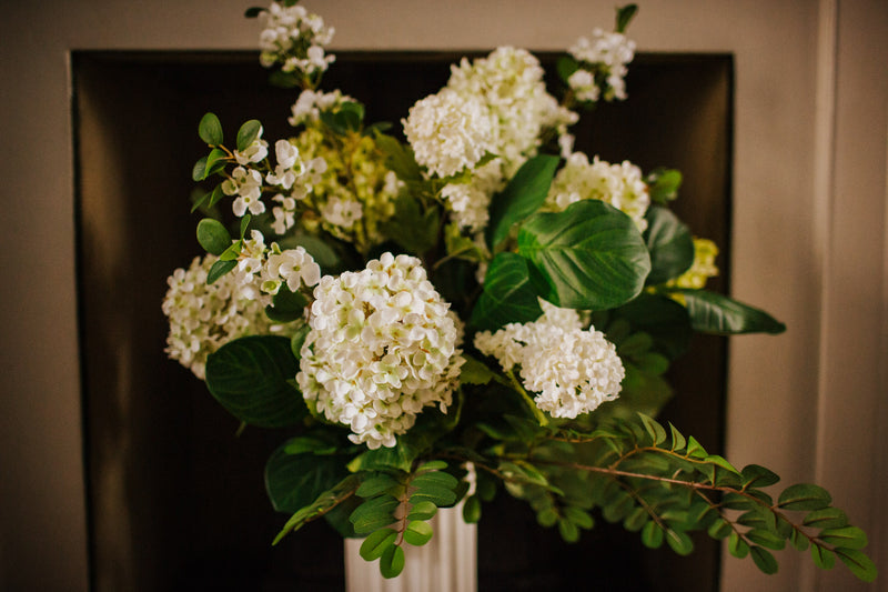 Luxury artificial hydrangea, orange blossom, viburnum and seasonal foliage. Expertly arranged by our team of florists into a tall white ceramic vase or available as a beautifully wrapped bouquet, perfect for larger spaces.
