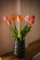 A deceptively realistic arrangement of timeless tulips. Expertly arranged by our team of florists into a green vase or available as a beautifully wrapped bouquet.