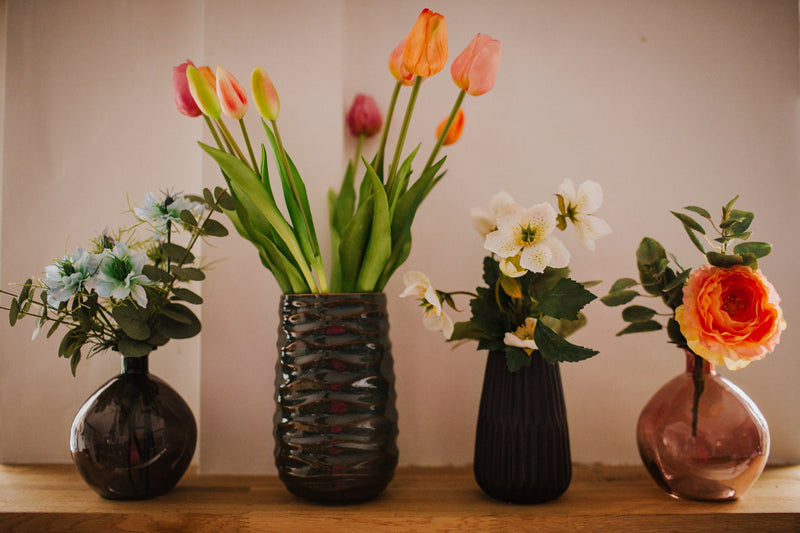 A deceptively realistic arrangement of timeless tulips. Expertly arranged by our team of florists into a green vase or available as a beautifully wrapped bouquet.