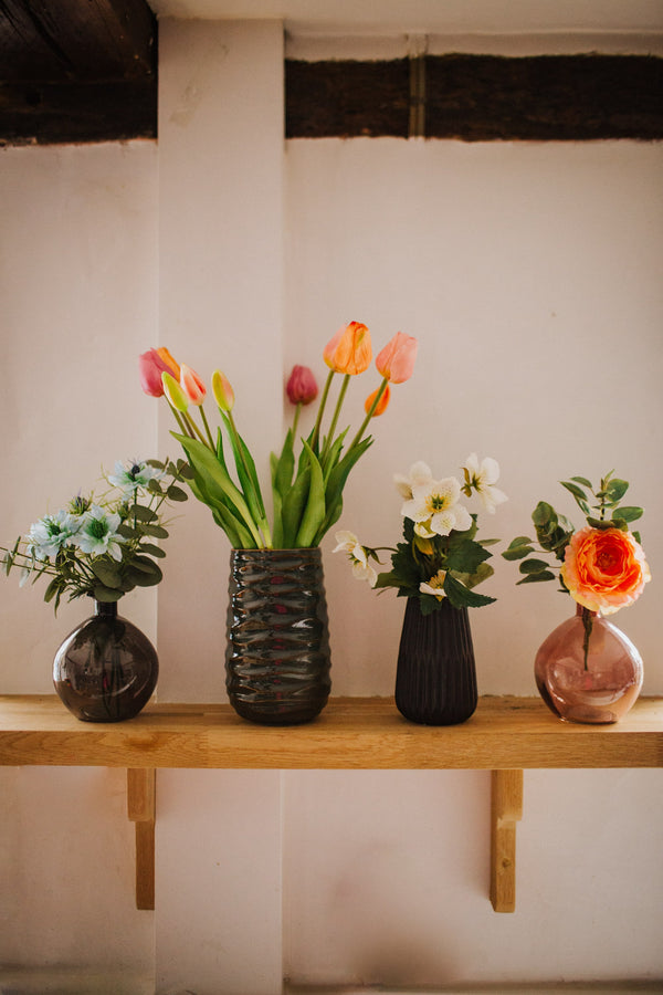 A deceptively realistic arrangement of timeless tulips. Expertly arranged by our team of florists into a green vase or available as a beautifully wrapped bouquet.