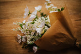 Luxury artificial white cosmos, delphinium, agapanthus and chrysanthemums mingled with the highest quality robinia and eucalyptus. Expertly arranged by our team of florists into a choice of white ceramic or green glass vase or available as a beautifully wrapped bouquet.