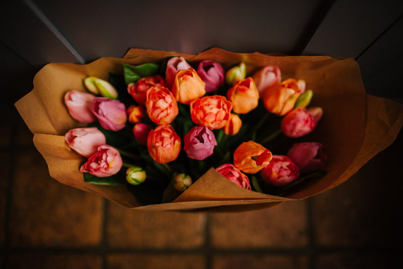 Luxury artificial tulips and salal foliage expertly arranged by our team of florists into a choice of dusky pink metal vase or light green glass vase or available as a beautifully wrapped bouquet.