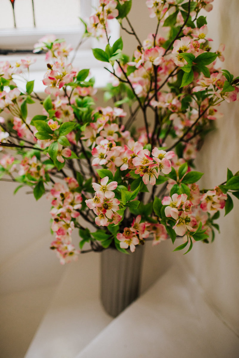 Realistic artificial Blossom flower arrangement in a chic off white vase perfect for the home or to gift.