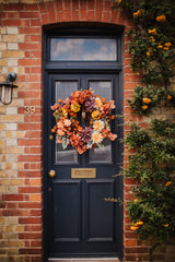 An explosion of scrumptious warm orange foliage, plum hydrangea and golden dahlia combine to create our irresistible Apple Crumble wreath.  This delicious concoction of autumnal favourites will guarantee guests a warm welcome through the winter months.